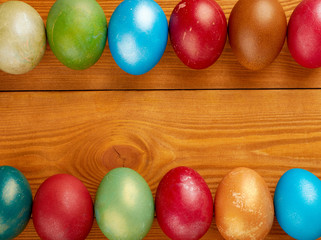 Colorful easter eggs on wooden background, free space for text