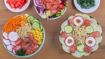 Raw fish, rice and healthy vegetables on a wooden background. Healthy eating concept