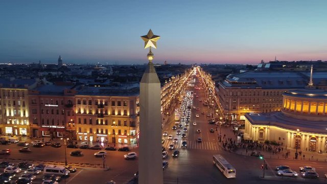 White nights. Drone around soviet star on top stella obelisk central square Petersburg Russia. Nevsky avenue backlight. Road active traffic junction. Subway station Historical cityscape downtown