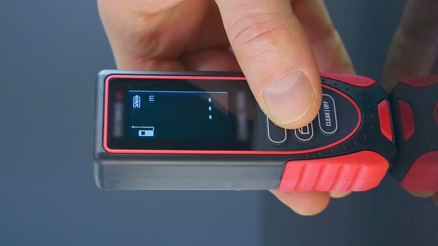 The modern device, which is very necessary in construction and repair - digital rangefinder - accurate measurement of the distance from the device to the target. Macro. Closeup. Shallow depth of field