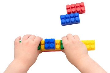 a child plays with a plastic construction kit