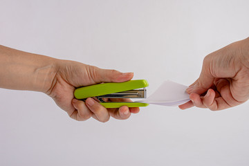 stapler, green stapler with hand pressed, stapling the paper by hands