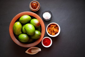 Homemade Raw green mango pickle. Preparation for spicy Kairiche lonche or aam ka achar. Ingredients...