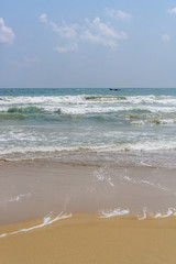 The beautiful Marina beach in Chennai, India with 2 fishing boats in the water. 