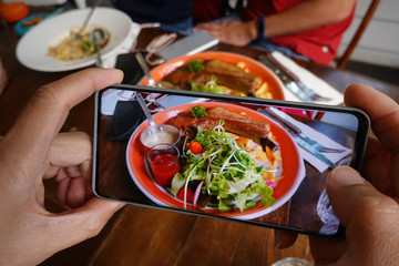 Food blogger using smartphone taking  picture and  share to social media instagram photography blogging workshop concept