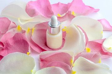 Obraz na płótnie Canvas Natural organic homemade cosmetics concept. Skin care (therapy), beauty products: containers with face serum among delicate rose flowers petals. Close up, mock up