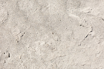 Sand texture with cracks in the sunlight.