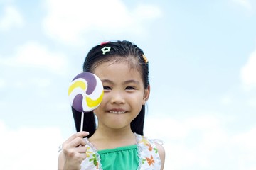 Girl holding a lollipop