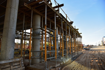 Naklejka premium Bridge construction project works. Roundabout traffic bridge construction and highway ramps. Road work on traffic highway, road intersection junction and freeway