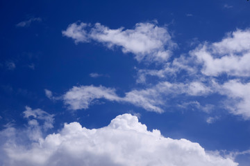 Naklejka na ściany i meble Mesmerizing clouds in a blue sky on a bright Sunny day