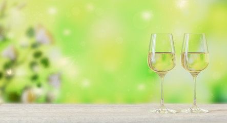 White wine on light green background. Two wineglasses of vino verde. Seasonal holidays concept