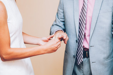 Fototapeta na wymiar hands of a couple of bride and groom exchanging wedding rings