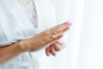 hands of the bride and wedding rings, shoulder of the bride

