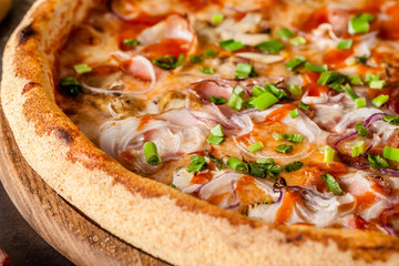 Italian Cuisine. Thin pizza with bacon, red onion, green onion and mushrooms in tomato sauce. Background image. copy space