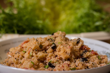the curly endive with breadcrumbs, black olives, tomatoes, eggs, oregano, garlic, parsley, salt. Vegetarian version. Typical Neapolitan dish of peasant origin..