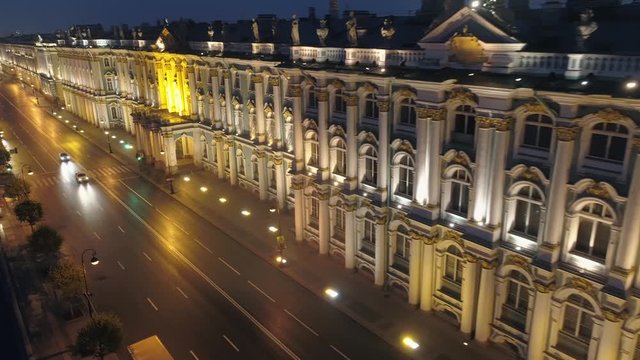 Flight backwards famous night Winter imperial palace Hermitage St. Petersburg backlight. Road traffic. Facade baroque style details. Historical old architectural monument. Travel attraction. Aerial