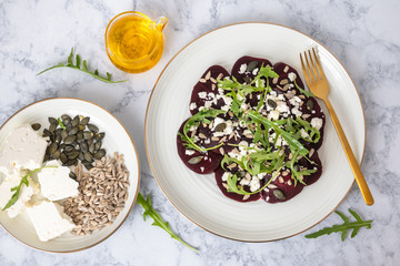 Beetroot carpaccio with feta cheese, rucola leaves, sunflower and pumpkin seeds.