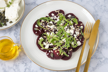 Beetroot carpaccio with feta cheese, rucola leaves, sunflower and pumpkin seeds.