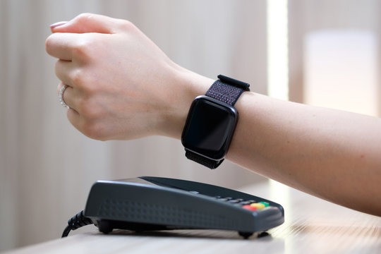 Woman pay by smart watch with NFC technology..