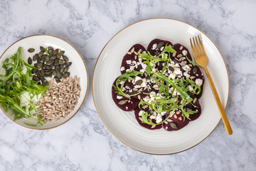Beetroot carpaccio with feta cheese, rucola leaves, sunflower and pumpkin seeds.