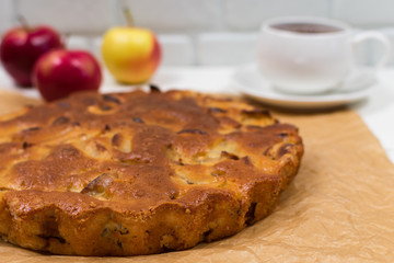 Homemade apple pie, in a plate, on a wooden table, ready to eat. Place for an inscription. Tea Party with Pie