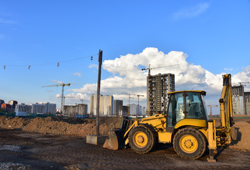 Yellow tractor with bucket at construction site