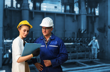  Industrial Engineers in Hard Hats  with  machine. Assist production engineer in industry.they checking metalwork control in industrial  factory