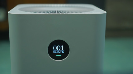air purifier machine. on the bed room at home, free space.increase in air humidity indoors, comfortable living conditions, Preventing allergies. PM 2.5 Dust value is 1