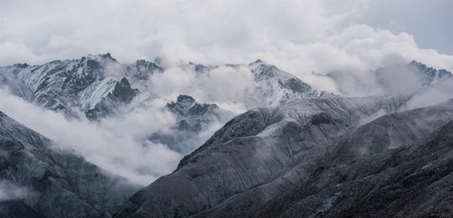 View of snow mountain surrounded by clouds with morning fog