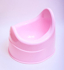 Toilet training chamber pot for small children. Potty pink on a white background.