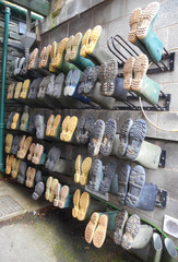 Wellington boots hanging in rows on rack