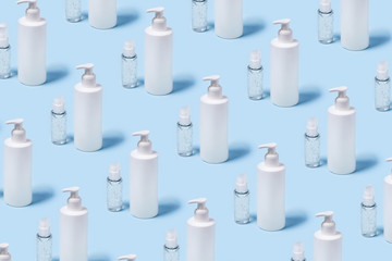 Blue background with medical supplies. Front view with a bottles of antiseptic soap and a hand sanitizer.