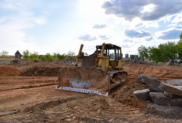 Bulldozer at landfill for work concrete demolition waste. Dozer at construction site during land...