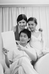 Fototapeta premium Man and two women looking at paper