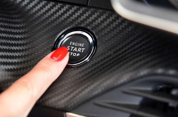 Women activates button to start and stop for car engine