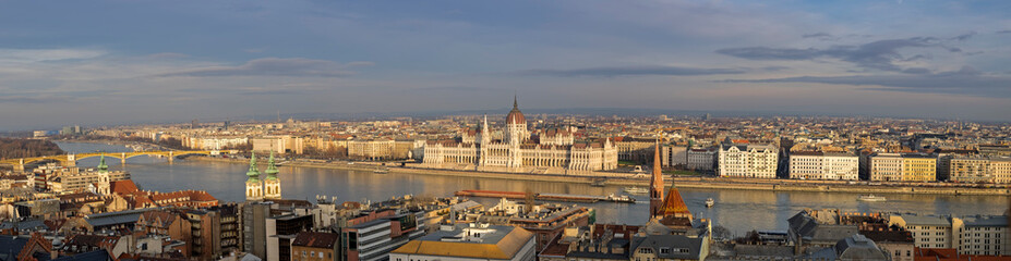 Very large Panoramic overview of Budapest Parliament on Danube river at sunset