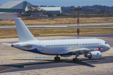 Fototapeta na wymiar Side view of a passenger plane while taxiing to runway.