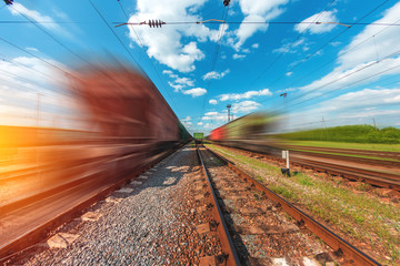freight, passenger train moves with speed by rail