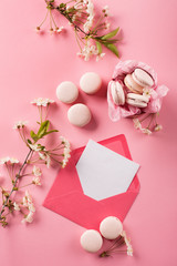 Roze macaroons in gift box and Cherry blossoms © Iuliia Metkalova