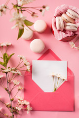 Roze macaroons in gift box and Cherry blossoms © Iuliia Metkalova