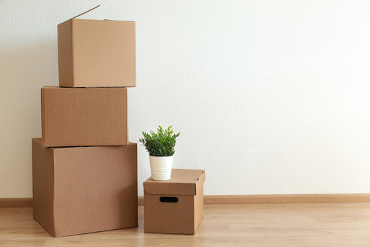 Cardboard boxes in empty room, movement concept.
