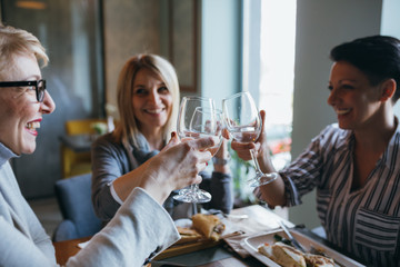 women having lunch break at restaurant, celebrating event