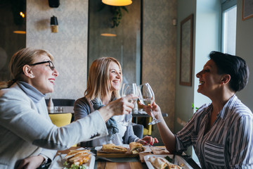women having lunch break at restaurant, celebrating event