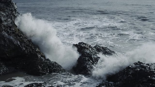 waves crashing about the coast's rocks in Iceland