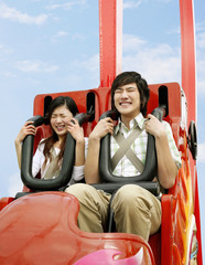 Man and woman on a roller coaster ride