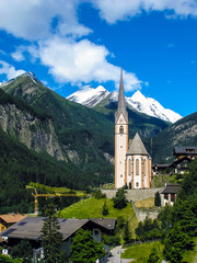 A church towering against the sky in the Alps, Heiligenblut, Austria