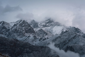 View of snow mountain surrounded by clouds with morning fog