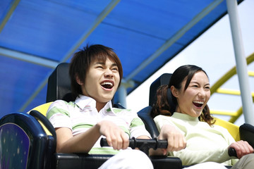 Man and woman on a rollercoaster ride