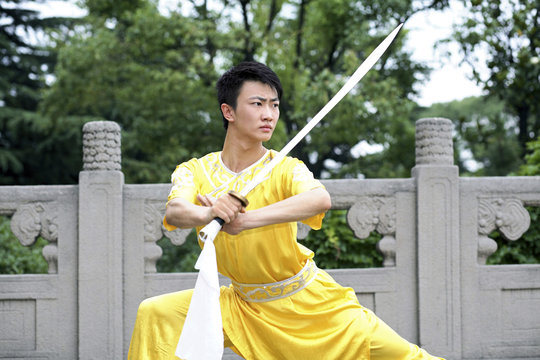 Man practising martial arts with a sword