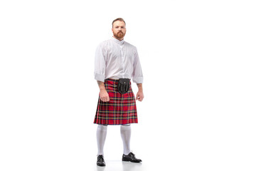 Scottish redhead bearded man in red tartan kilt on white background